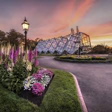 The Robert Clark Conservatory and colourful flower beds at Ballarat Botanical Gardens at twilight.