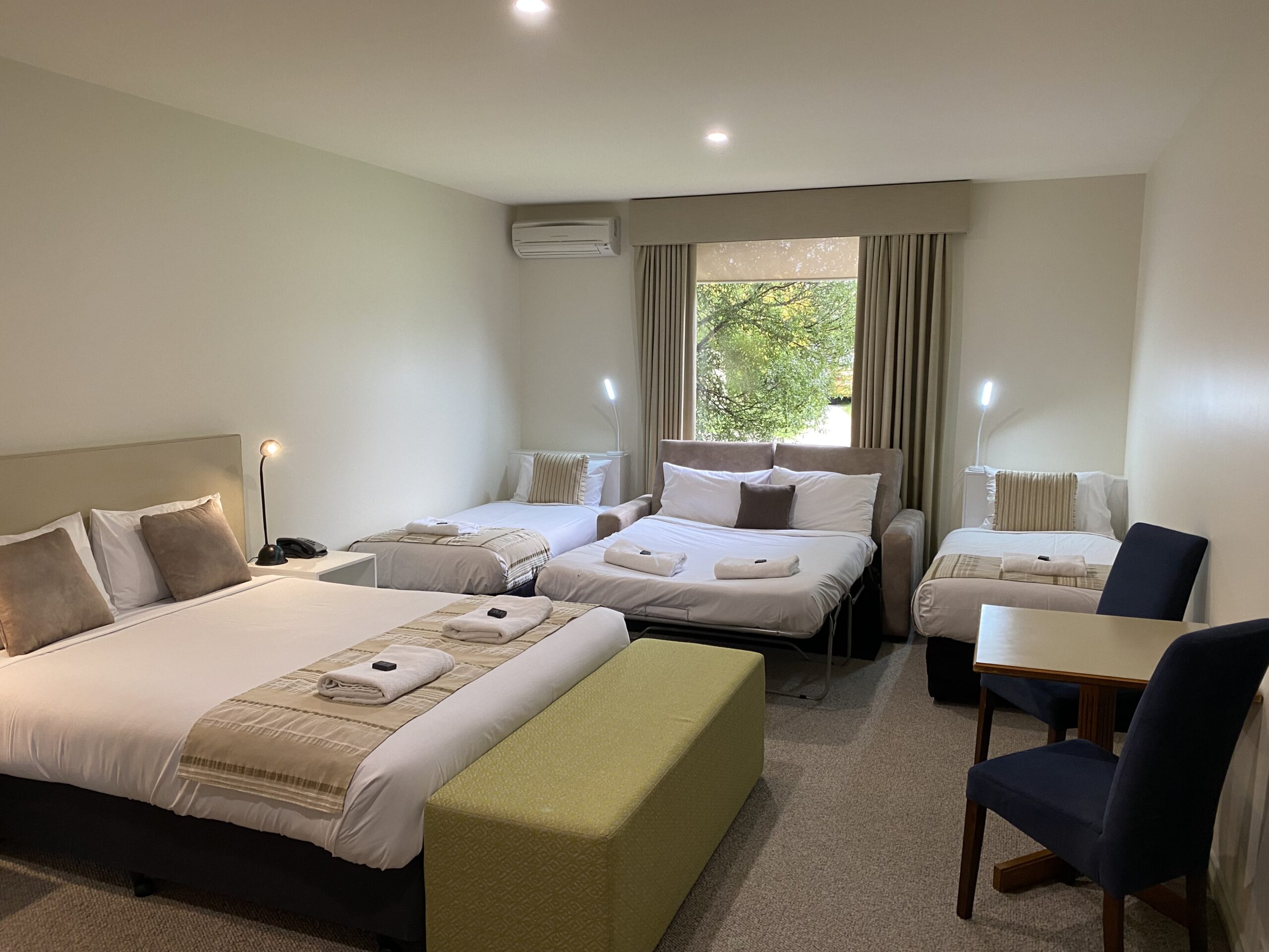 Wheelchair Friendly Family Room contains a queen bed, 2 sinle beds and a double fold out bed. The small kitchenette contains, a fridge, sink, microwave, kettle, toaster, cutlery and crockery.