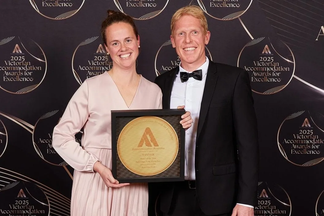 Two people hold the Motel of the Year award at the 2025 Victorian Accommodation Awards.