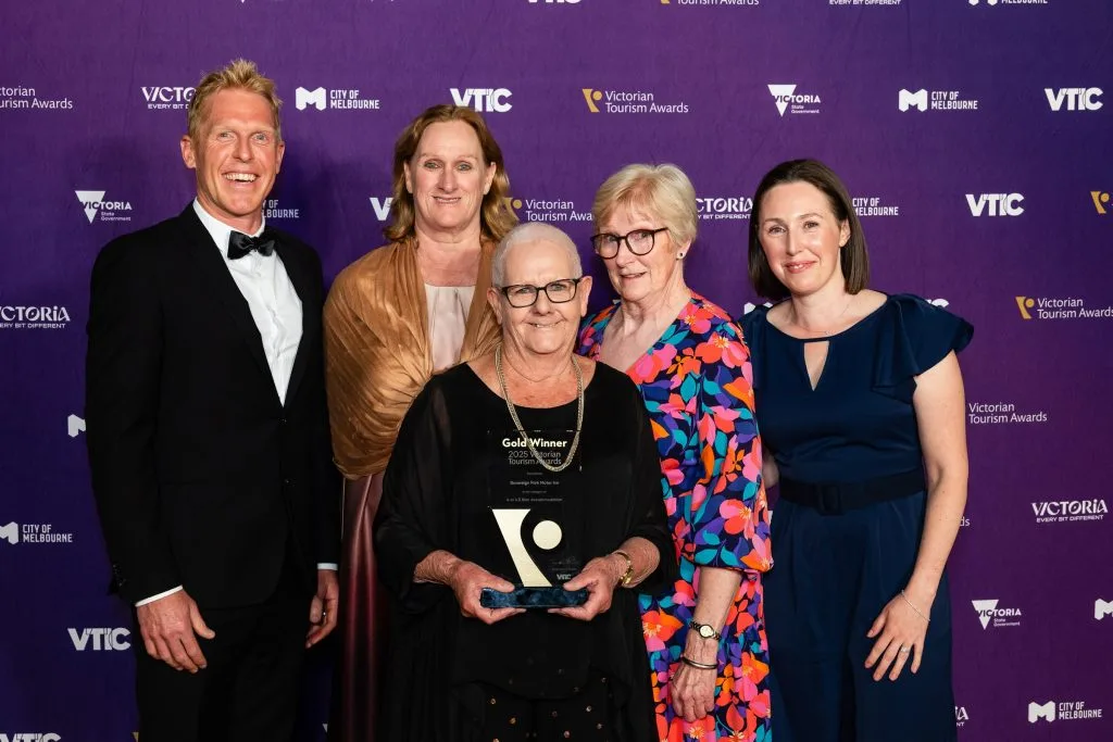Five people pose with the Gold Winner trophy for Sovereign Park Motor Inn.
